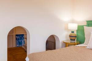 贝尼萨Villa Riu Blanc的一间卧室配有一张床和一张带台灯的桌子