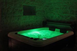 图里Albergo Diffuso Dimora Rossi的深色客房内的绿色浴缸