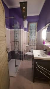 卡斯特罗维拉里Civico 4的带淋浴、卫生间和水槽的紫色浴室