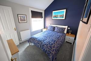 埃文河畔斯特拉特福海瑟薇住宿加早餐旅馆的蓝色的卧室设有床和窗户
