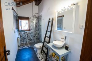 夸科斯德尤斯特Casa rural Paraje de Yuste的一间带水槽、卫生间和镜子的浴室