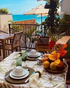 帕赖帕巴Beach Eco Stays Hotel Boutique Lagoinha的一张桌子,上面放着盘子,享有海景