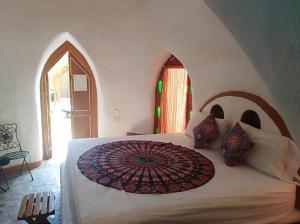 阿卡普尔科Wayahnb'al eco hostal的一间卧室配有一张带遮阳伞的床