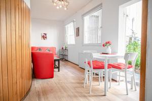 维也纳Timeless Red 1BR Apartment - Great for Longstays的客厅配有白色的桌子和椅子
