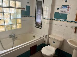 班泰第一海滩度假酒店的带浴缸、卫生间和盥洗盆的浴室