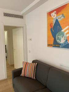 帕多瓦Appartamenti Scrovegni的客厅配有沙发和墙上的绘画