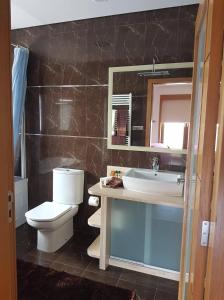 维拉诺瓦-德法马利Oktavihu House的一间带卫生间、水槽和镜子的浴室