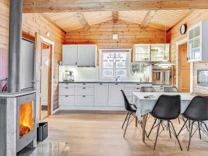 海默特6 person holiday home in Hemmet的厨房配有桌椅和壁炉。