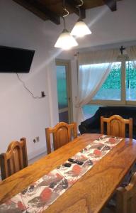 门多萨Departamento FAMILY的用餐室配有木桌、椅子和窗户