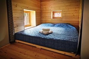 帕卢扎La Marmote Albergo Diffuso di Paluzza Faas的小木屋内一间卧室,配有一张床