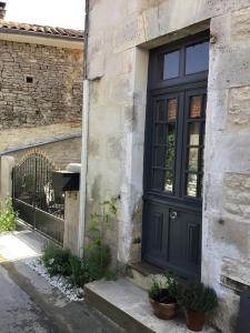 Verteuil-sur-CharenteLa Cour Blanche的建筑物一侧的黑色门