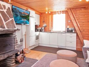 尼尔西艾Holiday Home Lomasyväri 810 by Interhome的小屋内的厨房配有白色橱柜和电视