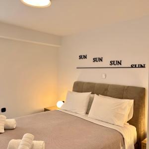 拉夫蒂港Becool Apartment的卧室配有一张挂有两个标志的床铺。