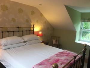 莫法特Cauldholm的卧室配有一张带白色床单的大床和窗户。