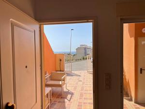 马萨龙El Alamillo ground floor apartment with sea view的客房享有带椅子和窗户的景致。