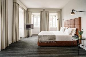 蒙特里尔Monte Real - Hotel, Termas & Spa的配有一张床和一台平面电视的酒店客房