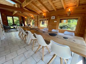 普兰凡Gîte Chalet avec bain nordique et piscine 11 pers Hautes Vosges的一张长木桌子和椅子