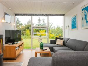 法贾德嘉德7 person holiday home in Ulfborg的带沙发和大窗户的客厅