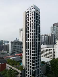 新加坡Novotel Living Singapore Orchard的城市中心高大的白色建筑