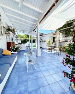 伊斯基亚La Bicocca di Annavì的庭院设有蓝色瓷砖地板和白色凉亭。