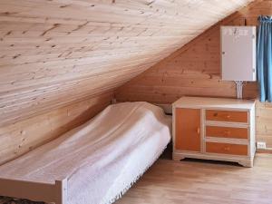 TranøyaHoliday home Tranøy的木墙客房的一张床位