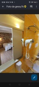 切萨雷奥港Villa Raggio di Sole parcheggio privato的一间带镜子的浴室和一间带床的房间