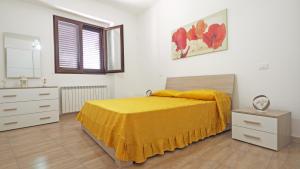 塔维亚诺Casa Manni Taviano-Salento的一间卧室配有一张黄色床罩的床