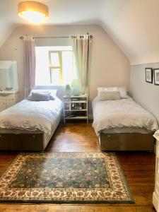 BalrathStone Lodge B&B的一间带两张床的卧室和地毯