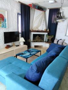 德雷斯House Kapetan Nono的客厅配有蓝色的沙发和电视