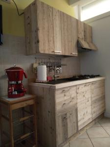 RovettaDA BRUNA的厨房配有木制橱柜和红色搅拌机