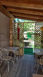 瓦尔玛德雷拉Locanda La Tana Del Luppolo的庭院配有桌椅和带围栏的墙壁。