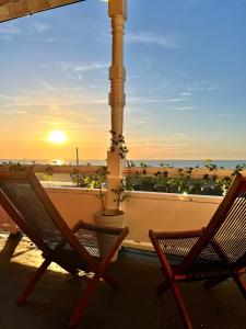 滨海韦斯特盖特SoHot Stays - Sea Views From Every Room的两把椅子坐在阳台上,欣赏日落美景
