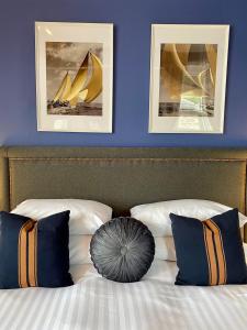 奥本Barriemore Oban的卧室配有一张墙上有两张照片的床。
