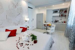 马奥莱Profumo di Mare Offre Parcheggio Gratuito的卧室配有带红色枕头的白色床