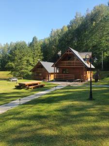BarłominoMana Village - Jacuzzi & Sauna的公园中央的小木屋