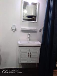 图阿马西纳Le Majestic Toamasina Hotel的浴室设有白色水槽和镜子