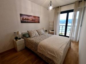 比韦罗Apartamento con balcón y vistas al mar的一间卧室设有一张床和一个大窗户