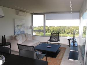 蒙得维的亚Faros de Carrasco Apartments的客厅配有沙发和桌子