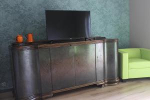 AltenhofLandperle Darze的木柜顶部的电视机,带绿椅