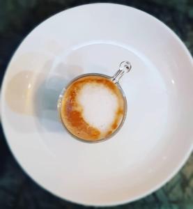 瓦拉纳西MONALISA HOSTEL的一杯咖啡在白盘上