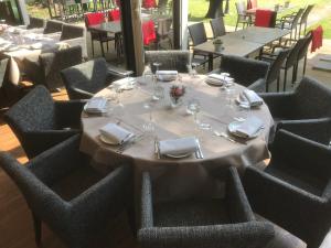 奥门Hotel & Restaurant Wildthout的餐厅的一张桌子,上面有白色的桌布