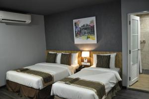 瓜拉丁加奴瓦亚酒店客房内的一张或多张床位