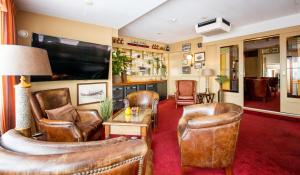 海边的艾格蒙特瓦西斯特拉德酒店的客厅配有真皮座椅和平面电视