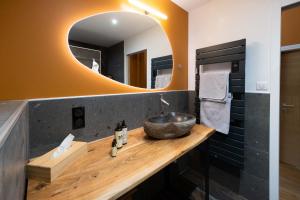 贝尔韦Domaine du Bugassou, Chambres, Table d'hôtes & SPA的一间带水槽和镜子的浴室