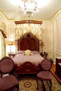 弗利玉兰住宿加早餐旅馆的一间卧室配有一张带吊灯的大型木床。