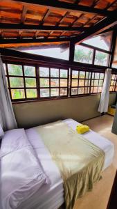 萨夸雷马Hostel Lagoa do Sol的配有窗户的客房内的一张大床