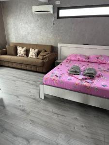 维纳斯Casa Florenta的卧室配有粉红色的床和沙发