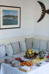 洛斯卡尼奥斯德梅卡马德雷瑟瓦酒店的沙发上一张桌子,上面有盘子和水果
