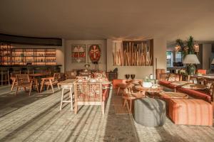古维亚Cook's Club Corfu - Adults Only的一间带桌椅的客厅和一间餐厅