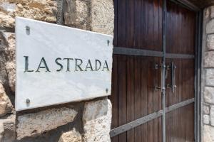 阿菲托斯Villa La Strada的建筑物一侧的拉斯特拉达标志
